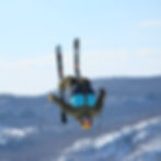 Maxime doing ski stunt on a ski hill