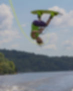 Maxime doing wake boarding on a lake