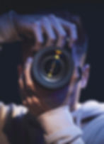 A black African-American focusing his camera to take a picture